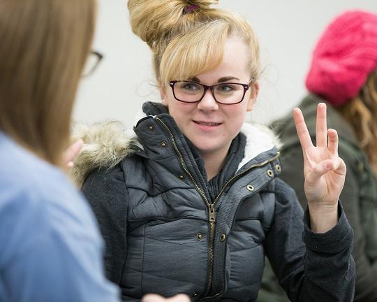 Hearing, female student learns letter W