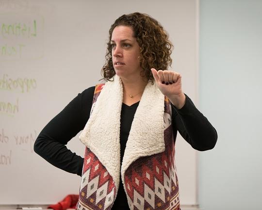 Deaf, female instructor teaches the letter A