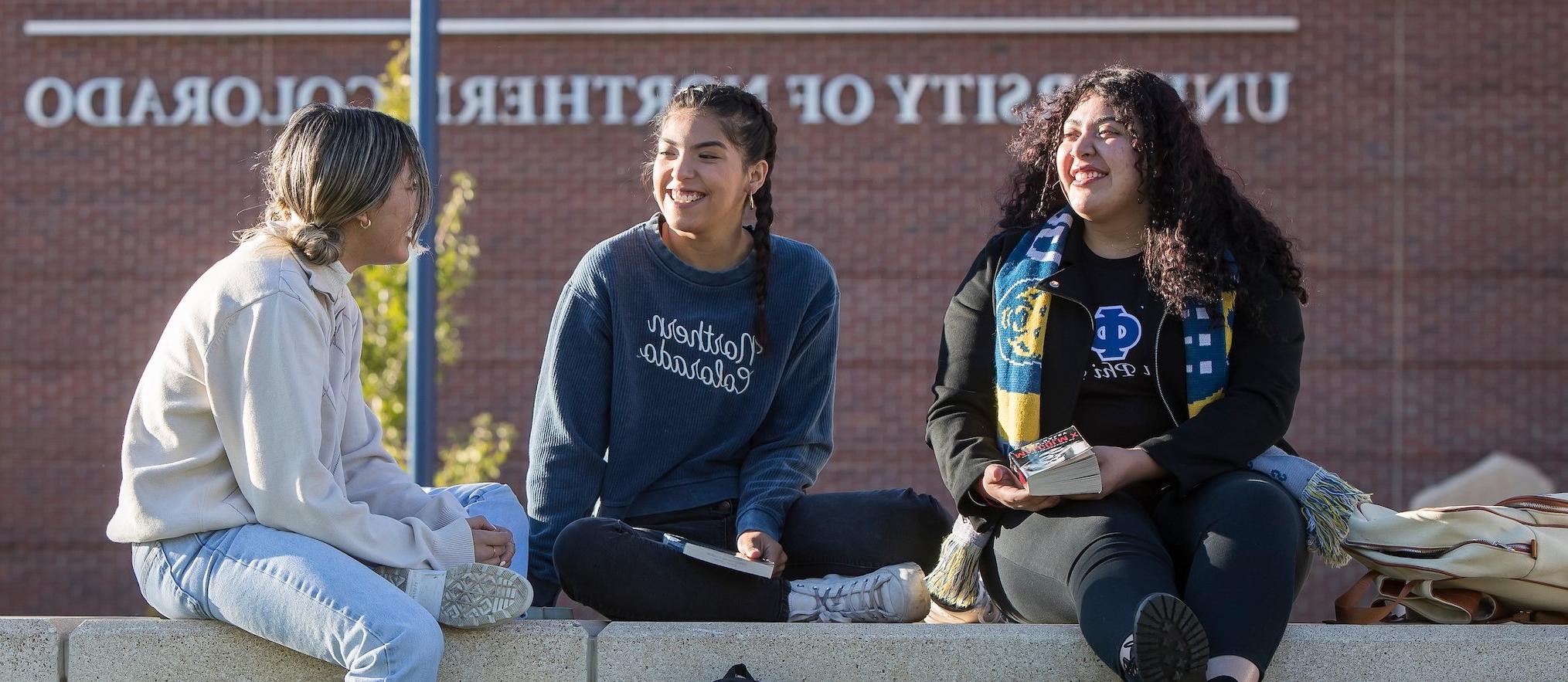 Three unc students in front of UNC campus commons 